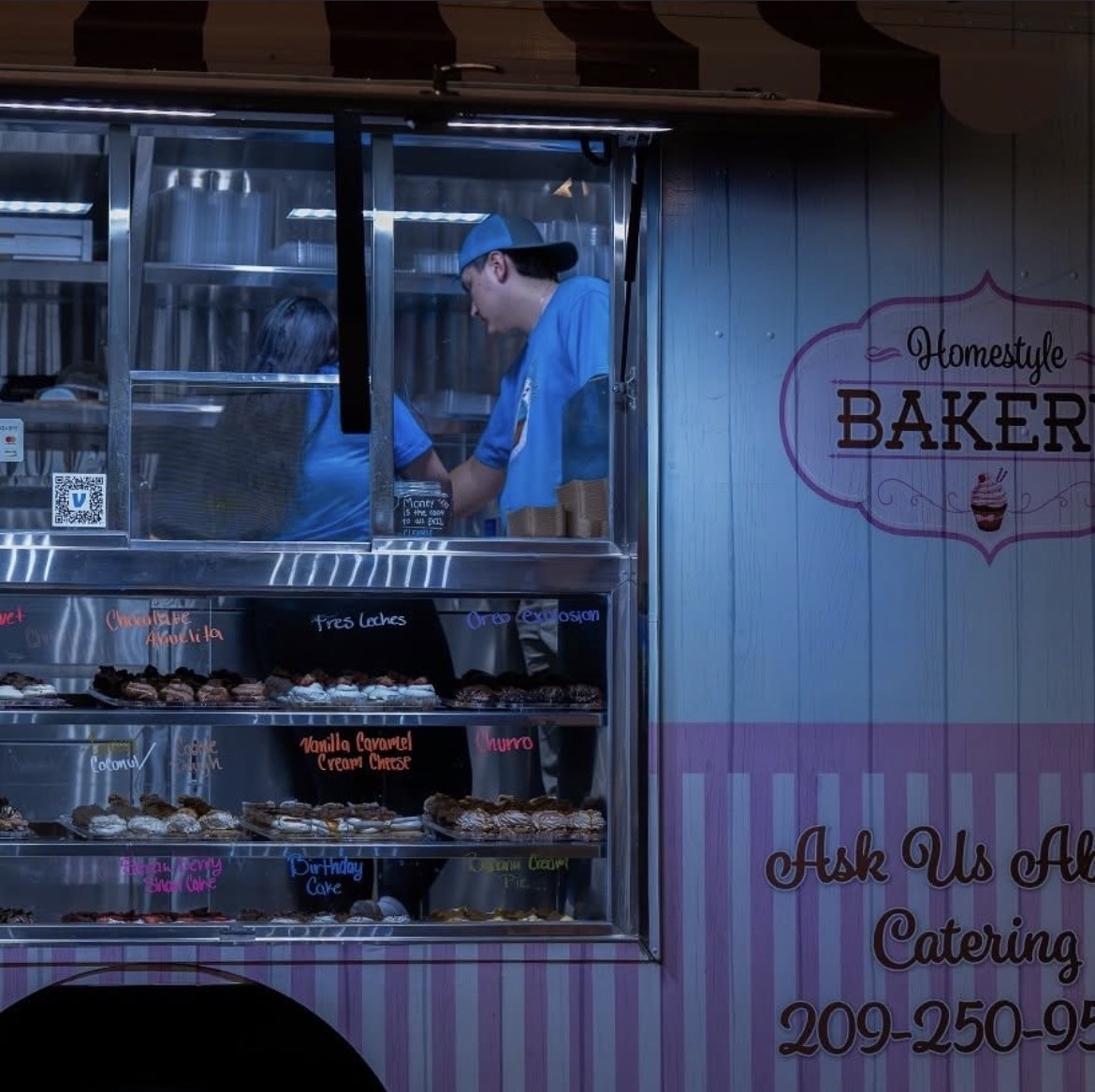 Workers preparing cupcakes inside the truck